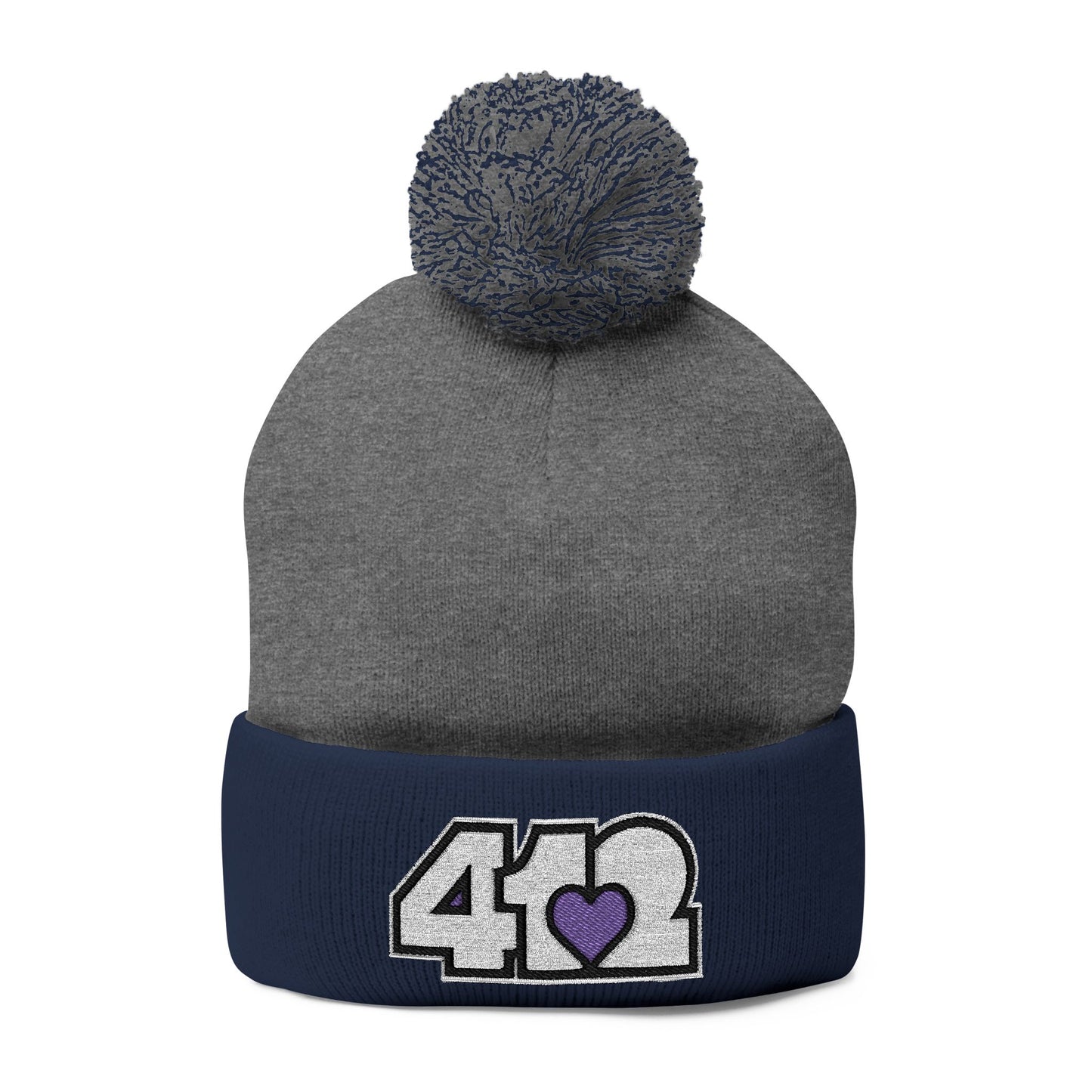 Cozy 412 Tossle Cap | Embroidered White and Purple Logo. Apparel Color: Dark Heather Grey / navy. Has soft acrylic knit, fold-over cuff, and one-size fit for winter comfort.