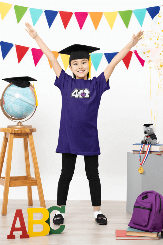 A cheerful child celebrating Back to School with a graduation cap, colorful decorations, and school supplies.