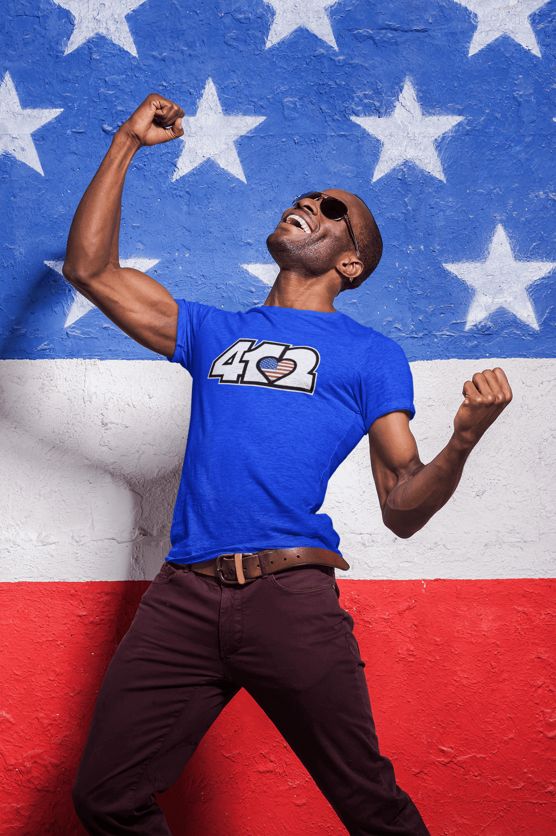 A Labor of Love: A man celebrating with excitement in front of an American flag backdrop.