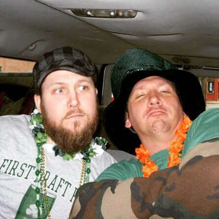 Two friends celebrating International Day of Friendship with playful expressions and festive attire in a car.