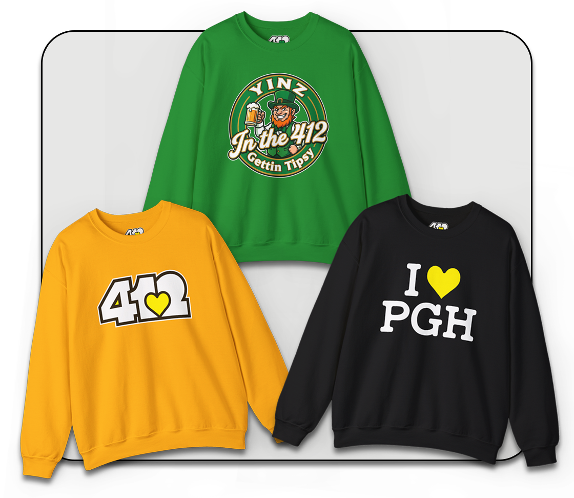 Model wearing a Holiday yellow 4OneLove2 crewneck sweatshirt in a festive living room with a Christmas tree.