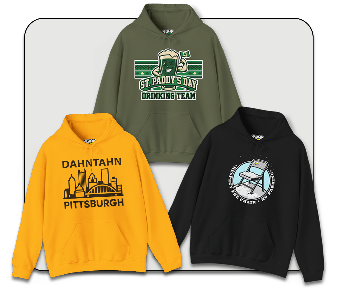 Man in a yellow hoodie and black scarf smiling while shoveling snow, showcasing comfortable hoodies in winter.