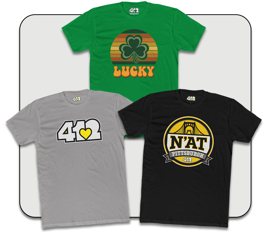 Stylish Graphic T-Shirts worn by a man in a snow-covered park with trees and benches in the background.