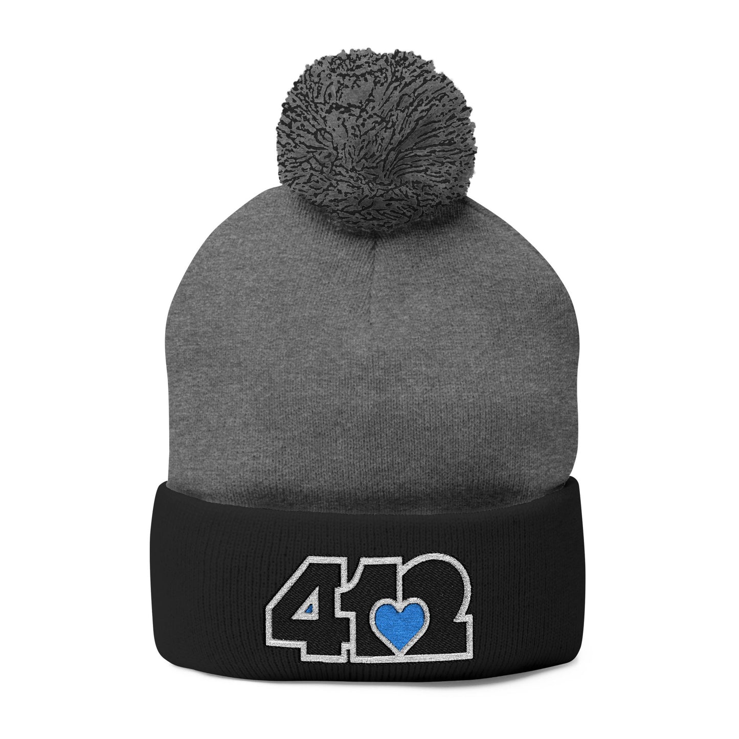 Cozy 412 Tossle Cap | Embroidered Black and Blue Logo. Apparel Color: Dark Heather Grey / Black. Has soft acrylic knit, fold-over cuff, and one-size fit for winter comfort.