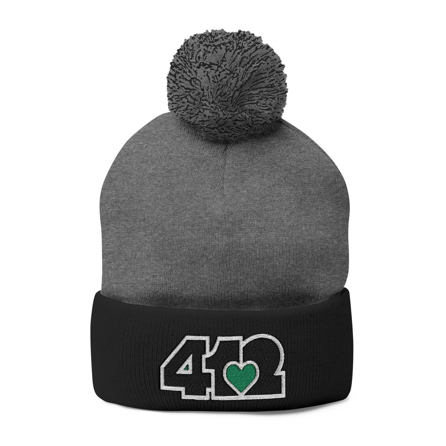 Cozy 412 Tossle Cap | Embroidered Black and Green Logo. Apparel Color: Dark Heather Grey / Black. Has soft acrylic knit, fold-over cuff, and one-size fit for winter comfort.