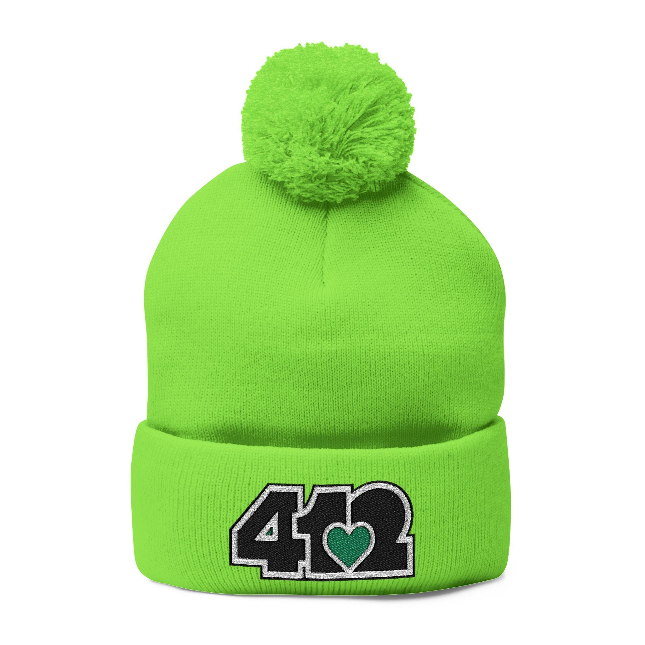 Cozy 412 Tossle Cap | Embroidered Black and Green Logo. Apparel Color: Neon Green. Has soft acrylic knit, fold-over cuff, and one-size fit for winter comfort.