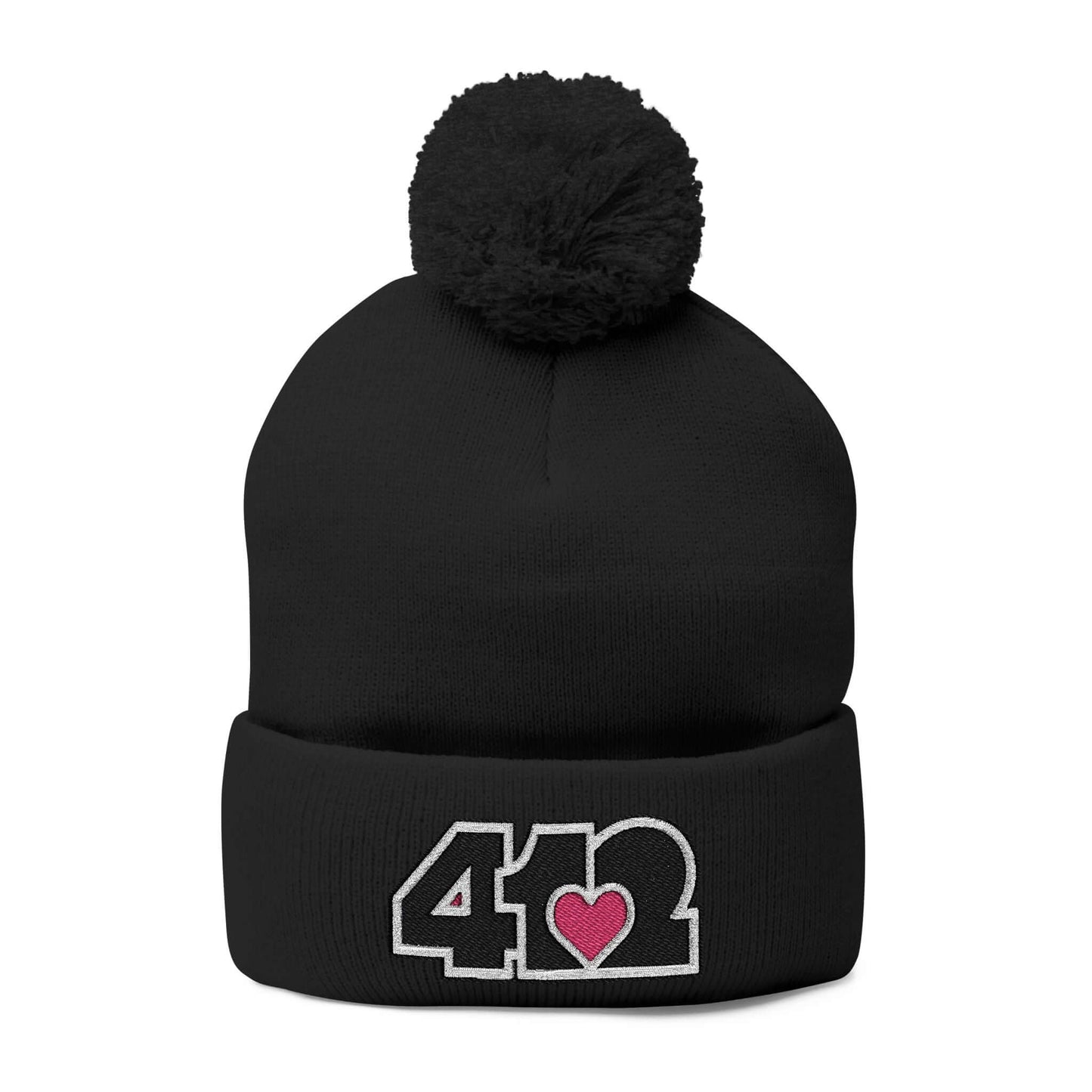 Cozy 412 Tossle Cap | Embroidered Black and Pink Logo. Apparel Color: Black. Has soft acrylic knit, fold-over cuff, and one-size fit for winter comfort.