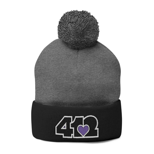 Cozy 412 Tossle Cap | Embroidered Black and Purple Logo. Apparel Color: Dark Heather Grey / Black. Has soft acrylic knit, fold-over cuff, and one-size fit for winter comfort.