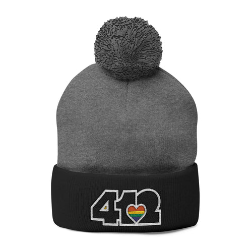 Cozy 412 Tossle Cap | Embroidered Black and Rainbow Logo. Apparel Color: Dark Heather Grey / Black. Has soft acrylic knit, fold-over cuff, and one-size fit for winter comfort.