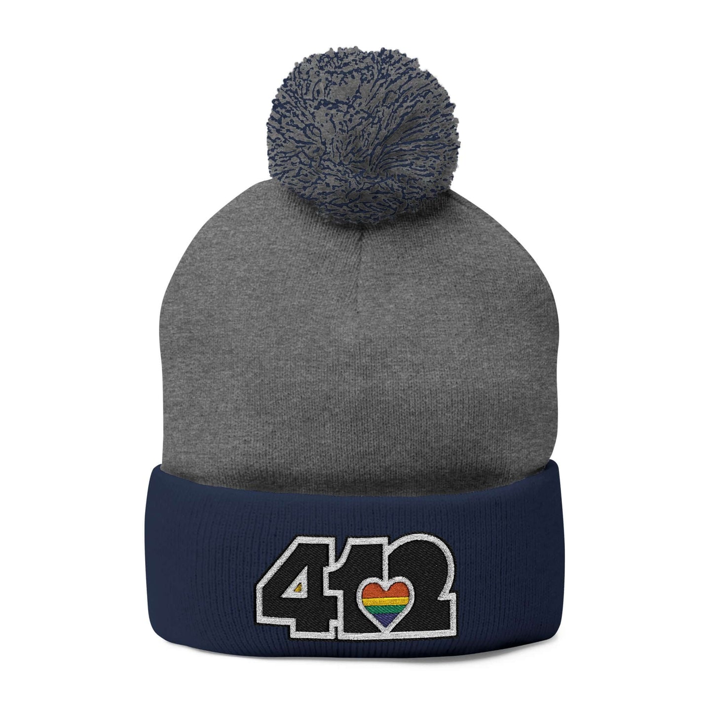 Cozy 412 Tossle Cap | Embroidered Black and Rainbow Logo. Apparel Color: Dark Heather Grey / navy. Has soft acrylic knit, fold-over cuff, and one-size fit for winter comfort.