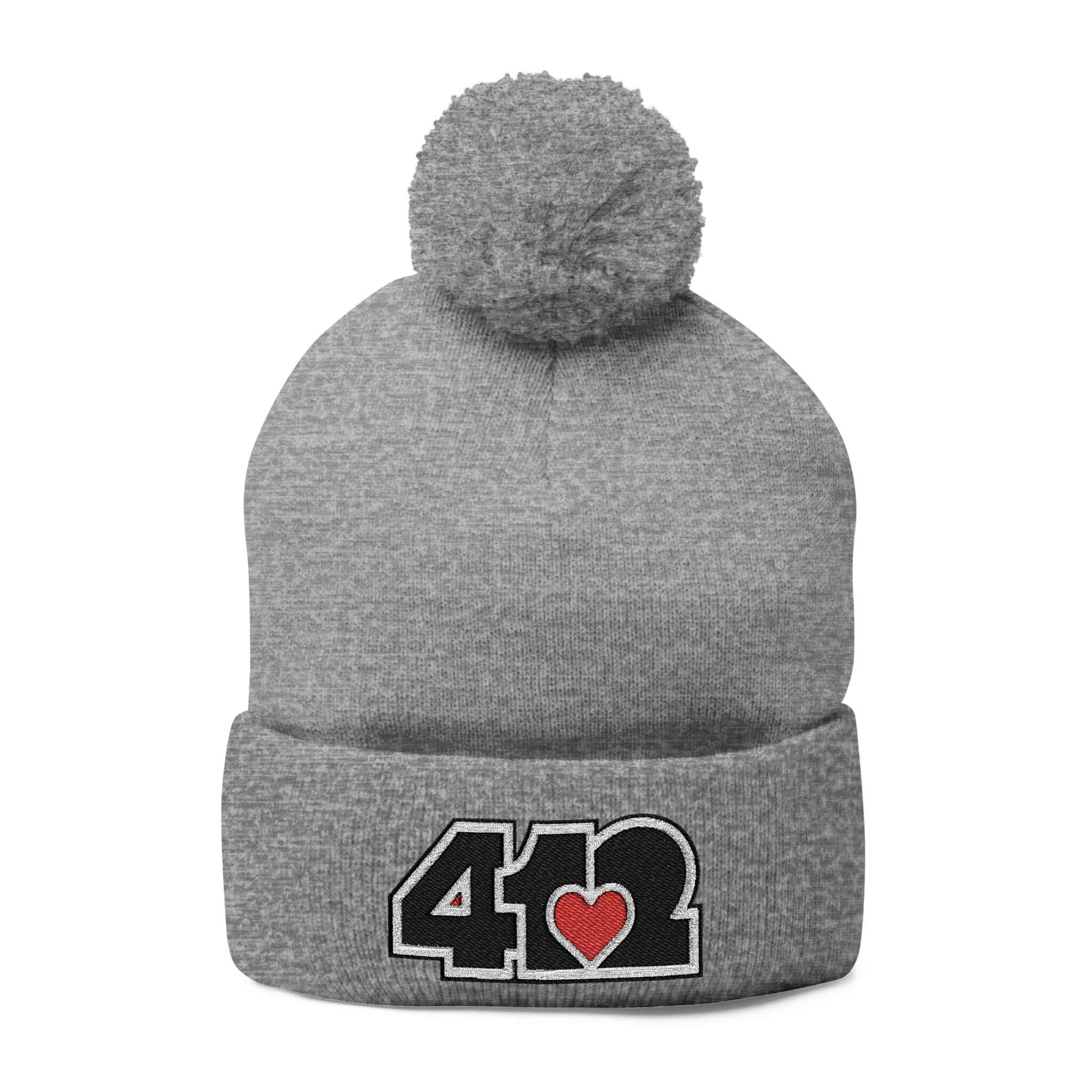 Cozy 412 Tossle Cap | Embroidered Black and Red Logo. Apparel Color: Heather Grey. Has soft acrylic knit, fold-over cuff, and one-size fit for winter comfort.