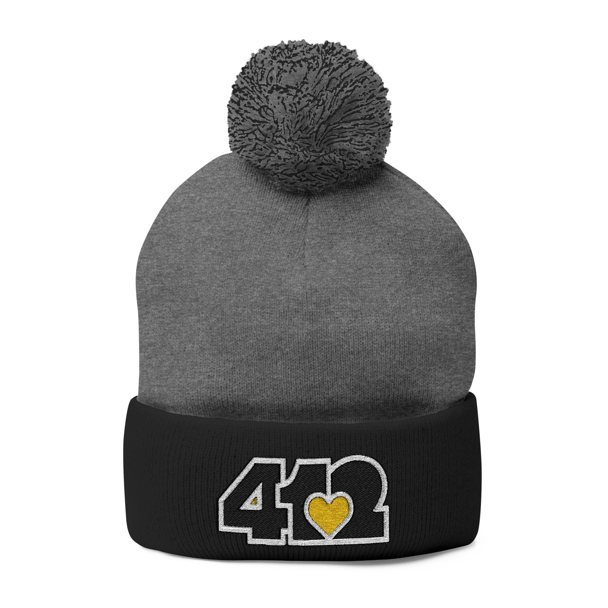 Cozy 412 Tossle Cap | Embroidered Black and Yellow Logo. Apparel Color: Dark Heather Grey / Black. Has soft acrylic knit, fold-over cuff, and one-size fit for winter comfort.