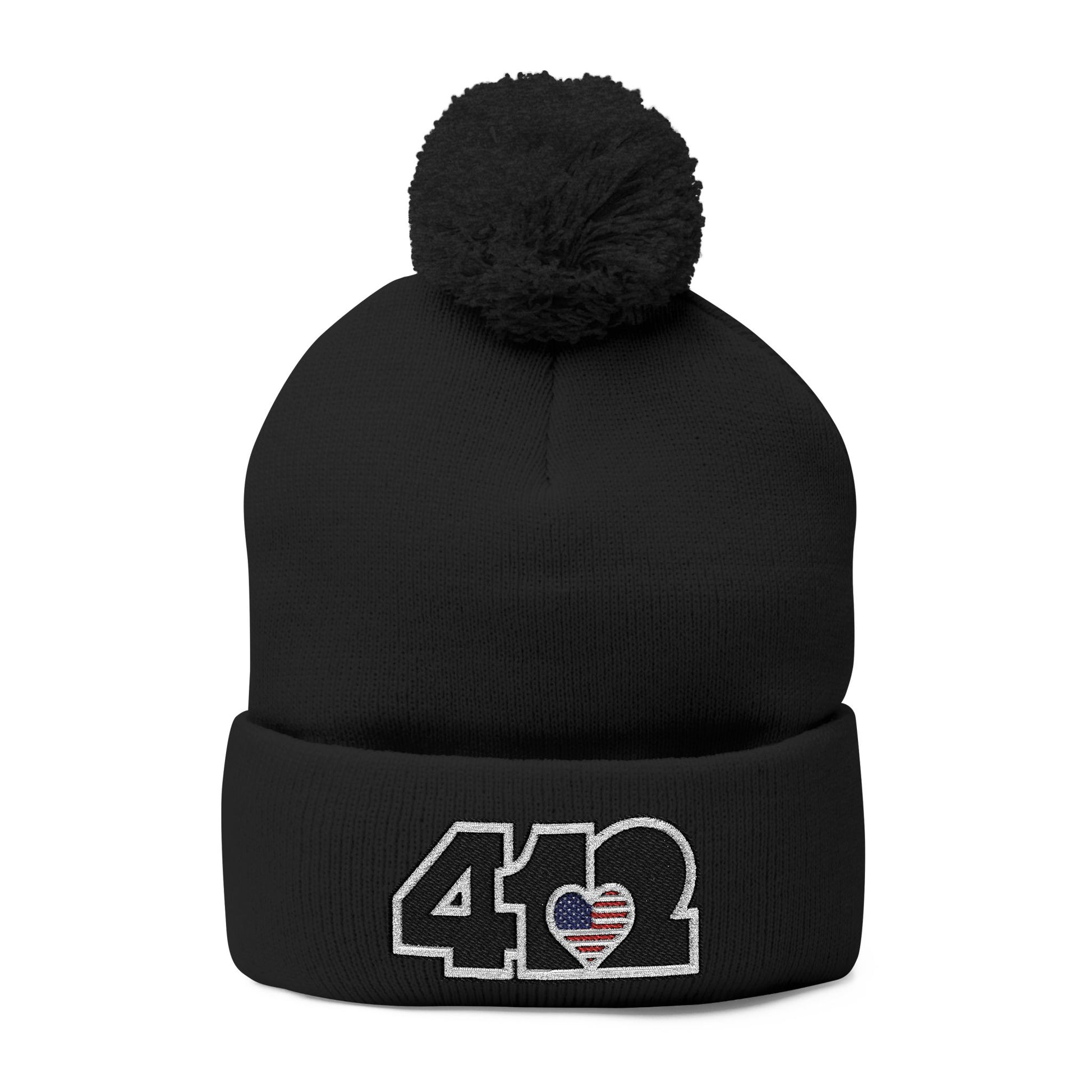 Cozy 412 Tossle Cap | Embroidered Stars & Stripes Black Logo. Apparel Size: One size. Has soft acrylic knit, fold-over cuff, and one-size fit for winter comfort.