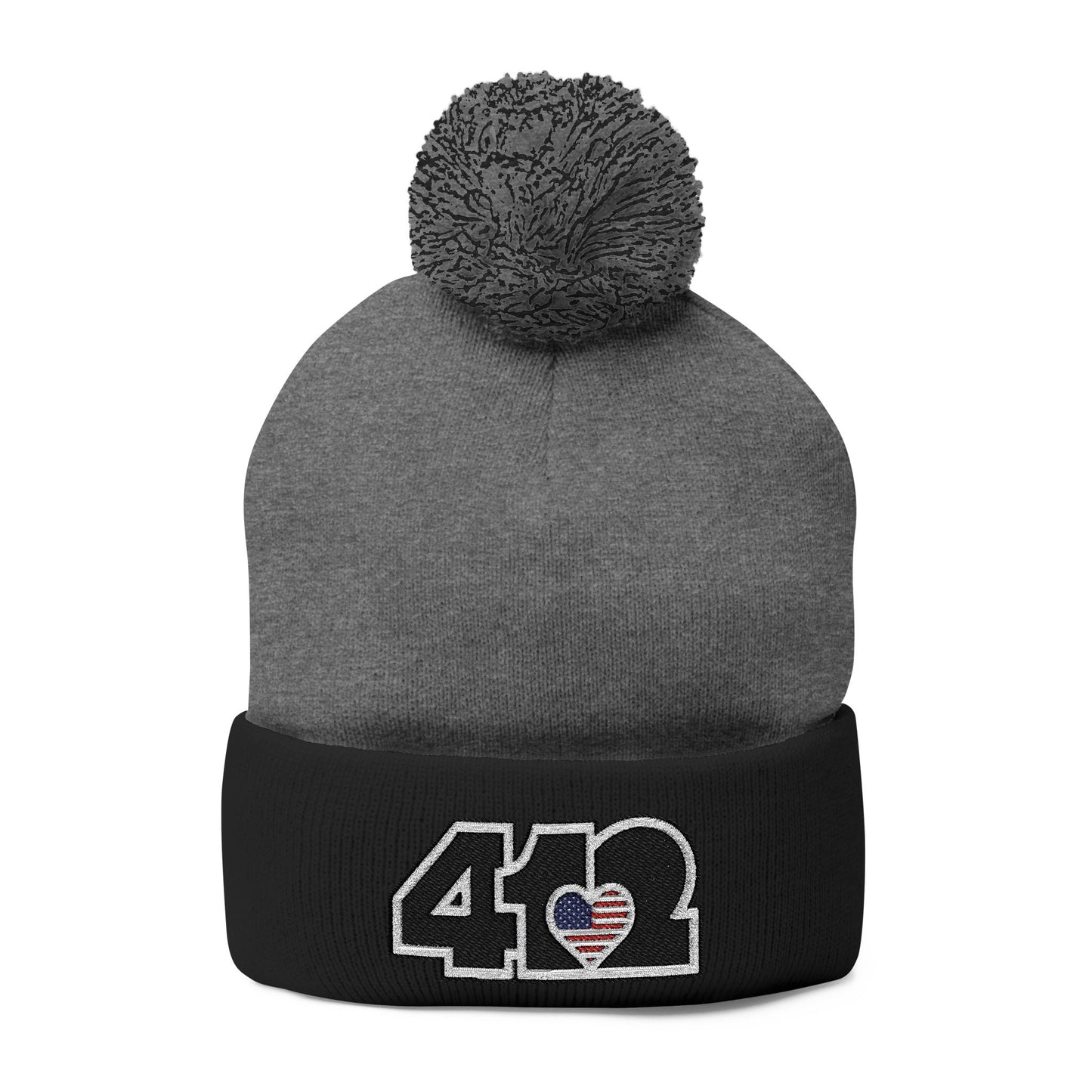 Cozy 412 Tossle Cap | Embroidered Stars & Stripes Black Logo. Apparel Size: One size. Has soft acrylic knit, fold-over cuff, and one-size fit for winter comfort.