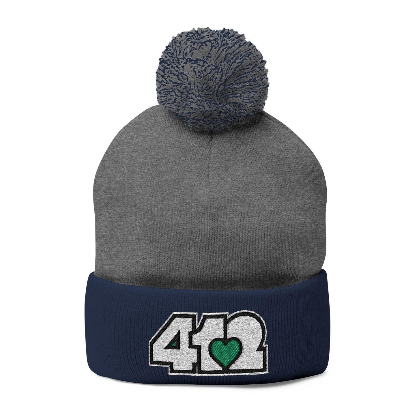 Cozy 412 Tossle Cap | Embroidered White and Green Logo. Apparel Color: Dark Heather Grey / navy. Has soft acrylic knit, fold-over cuff, and one-size fit for winter comfort.