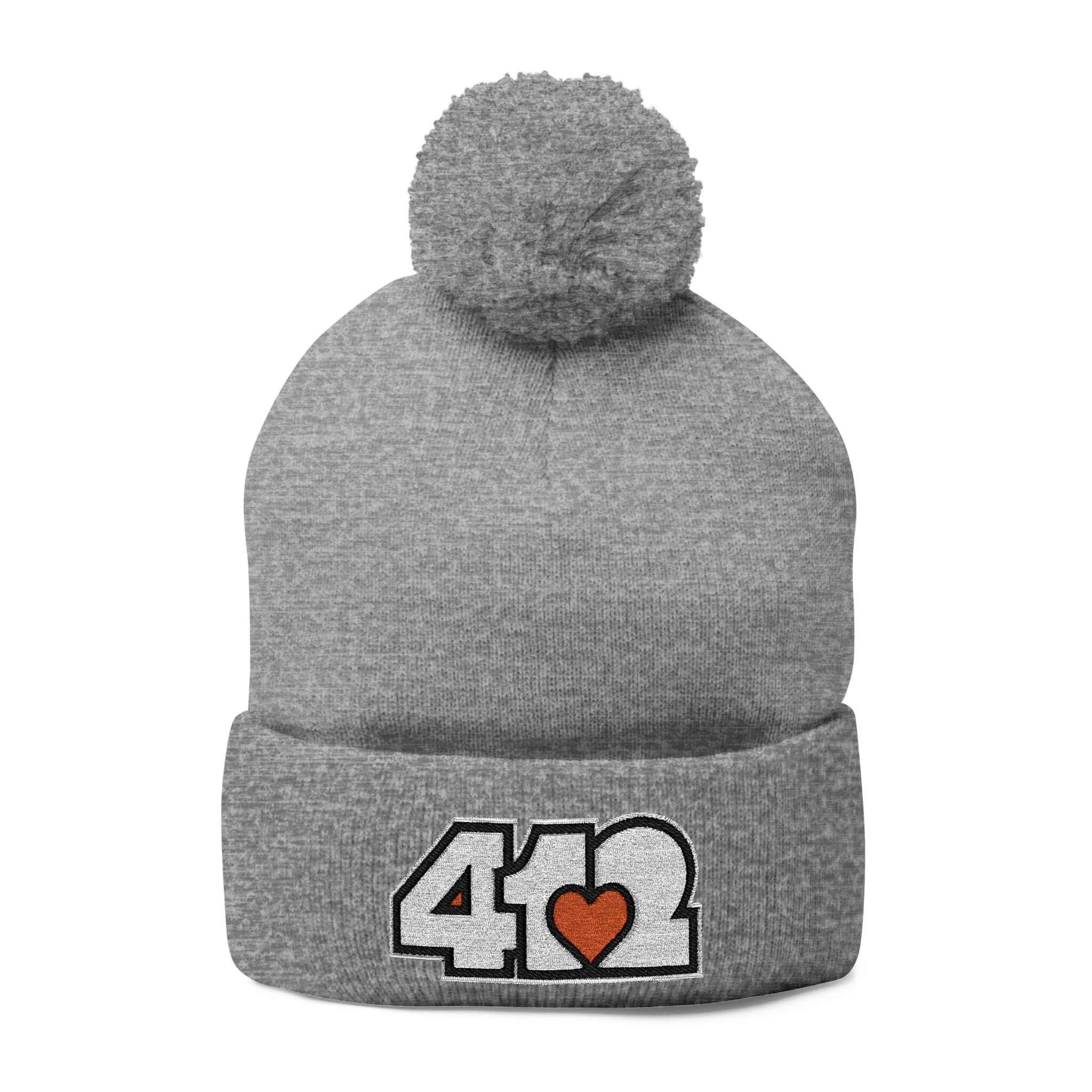Cozy 412 Tossle Cap | Embroidered White and Orange Logo. Apparel Color: Heather Grey. Has soft acrylic knit, fold-over cuff, and one-size fit for winter comfort.