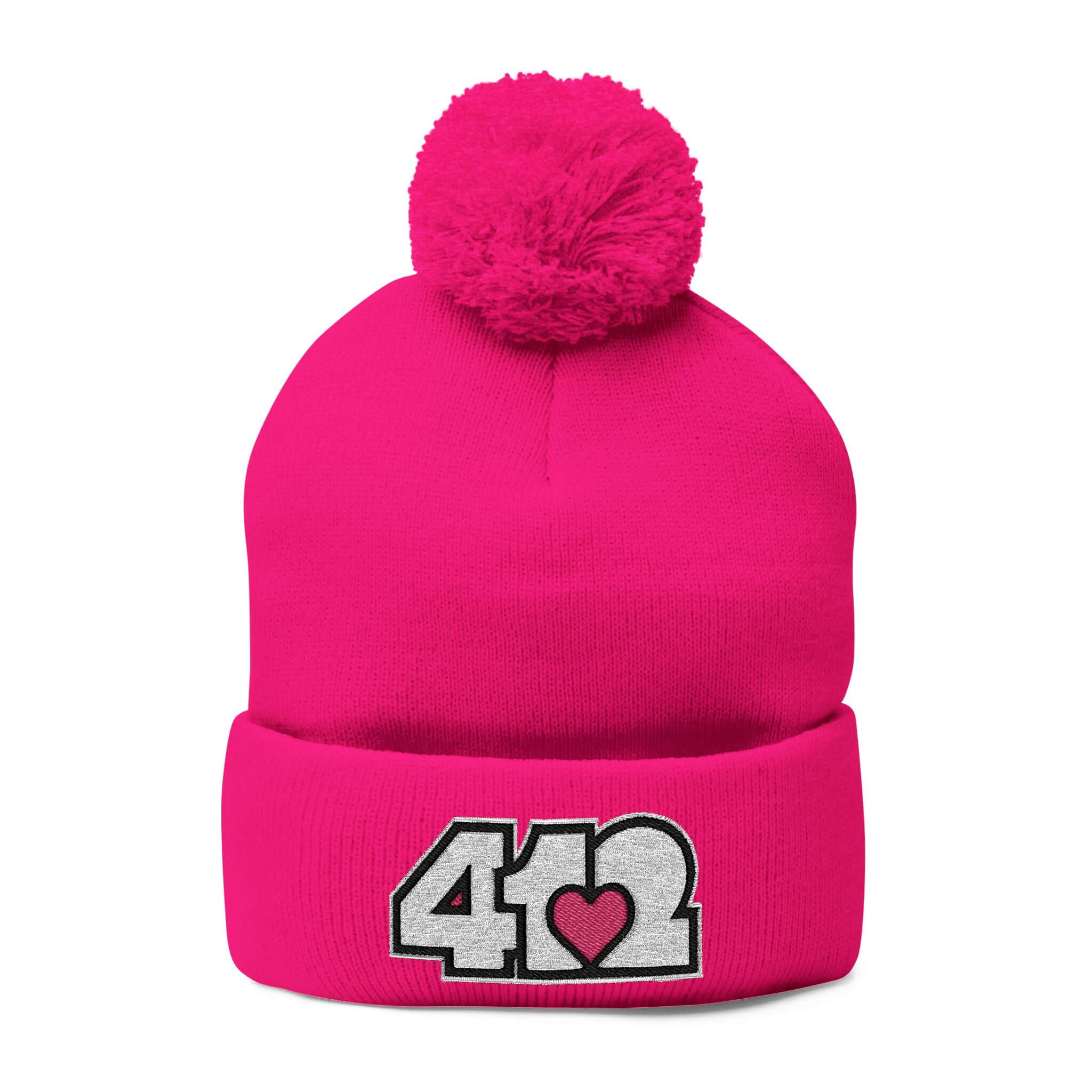 Cozy 412 Tossle Cap | Embroidered White and Pink Logo. Apparel Color: Neon Pink. Has soft acrylic knit, fold-over cuff, and one-size fit for winter comfort.