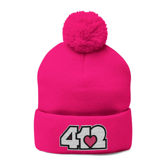 Cozy 412 Tossle Cap | Embroidered White and Pink Logo. Apparel Color: Neon Pink. Has soft acrylic knit, fold-over cuff, and one-size fit for winter comfort.