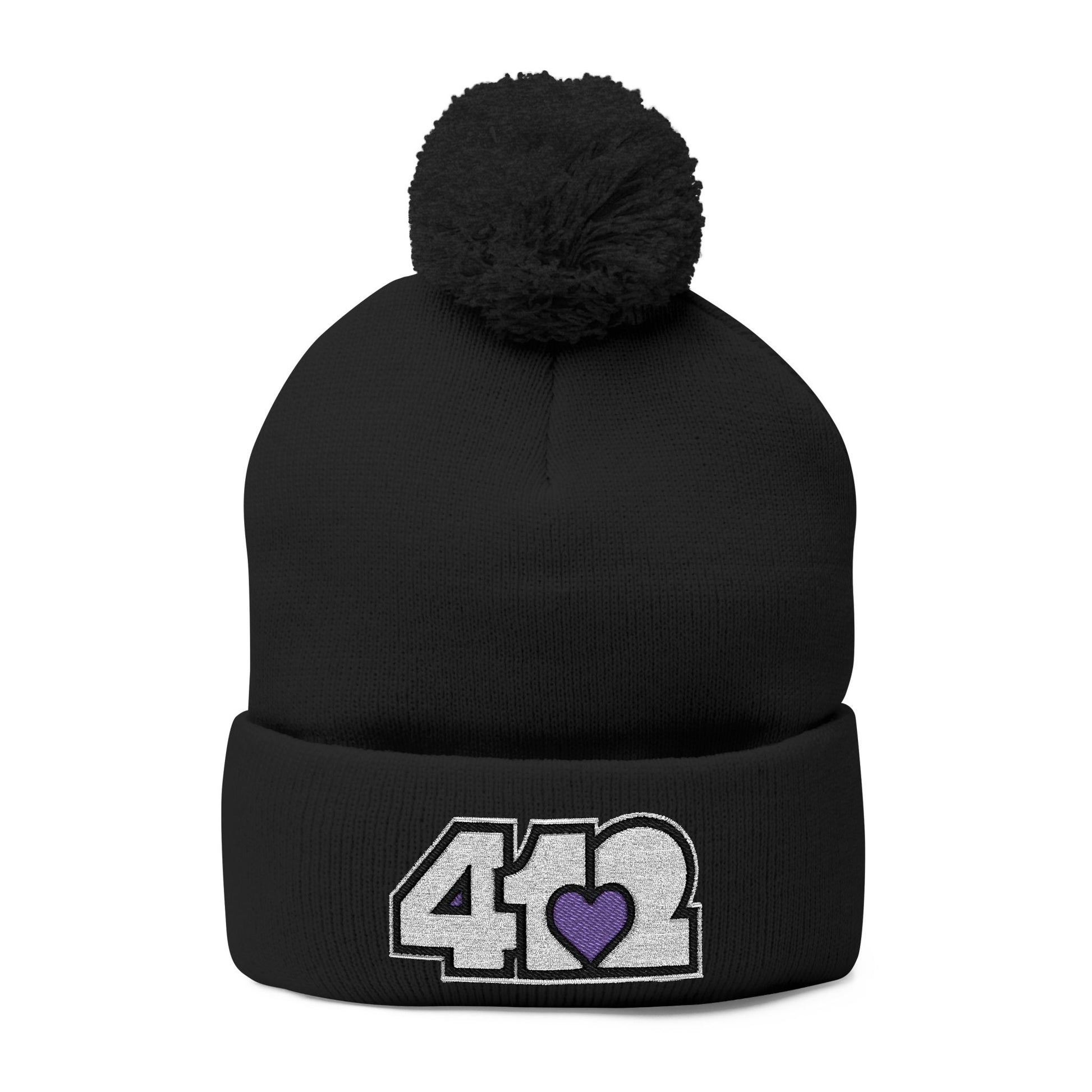 Cozy 412 Tossle Cap | Embroidered White and Purple Logo. Apparel Color: Black. Has soft acrylic knit, fold-over cuff, and one-size fit for winter comfort.