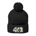 412 Tossle Cap | Embroidered White and Rainbow Logo. Apparel Color: Black. Has soft acrylic knit, fold-over cuff, and one-size fit for winter comfort.