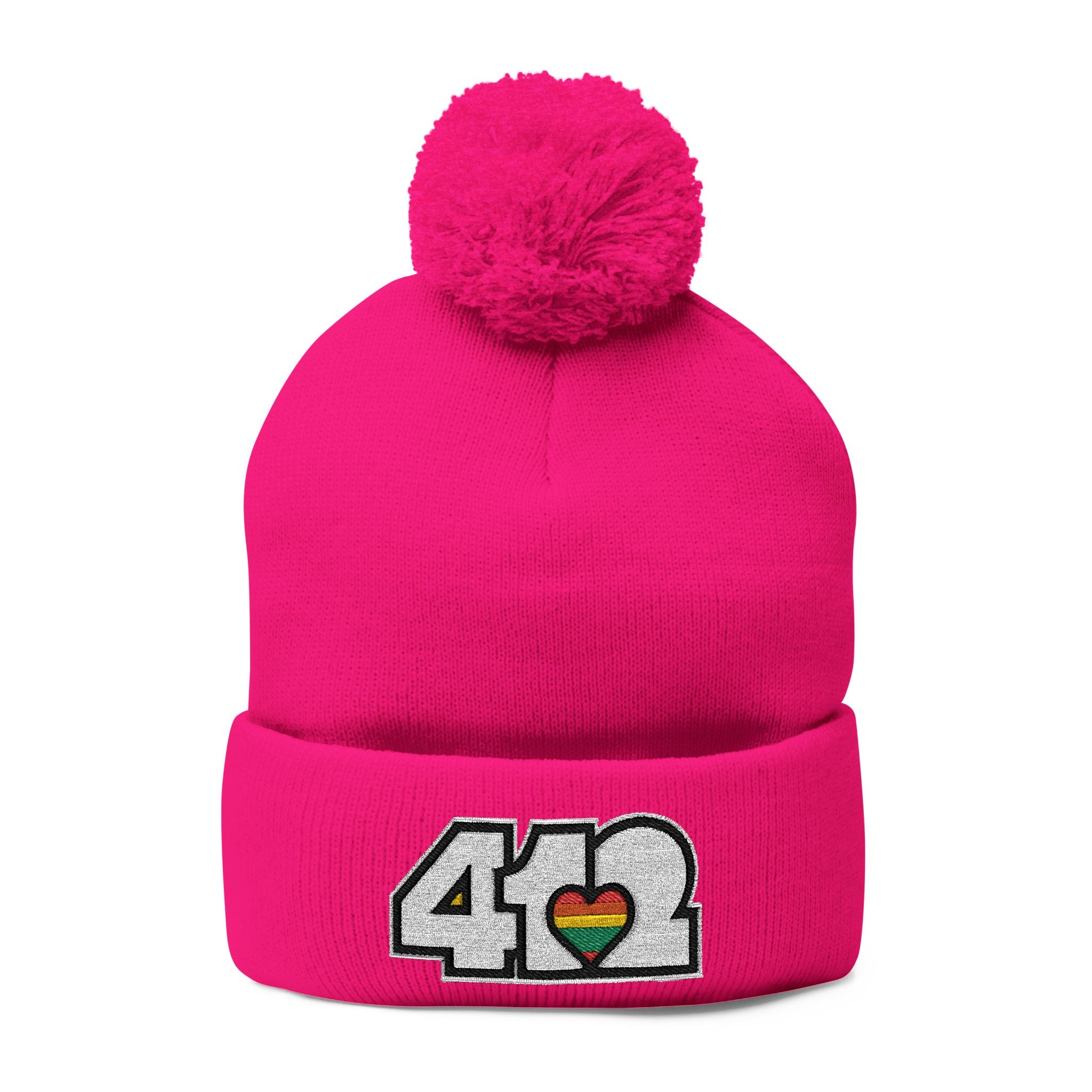 412 Tossle Cap | Embroidered White and Rainbow Logo. Apparel Color: Neon Pink. Has soft acrylic knit, fold-over cuff, and one-size fit for winter comfort.