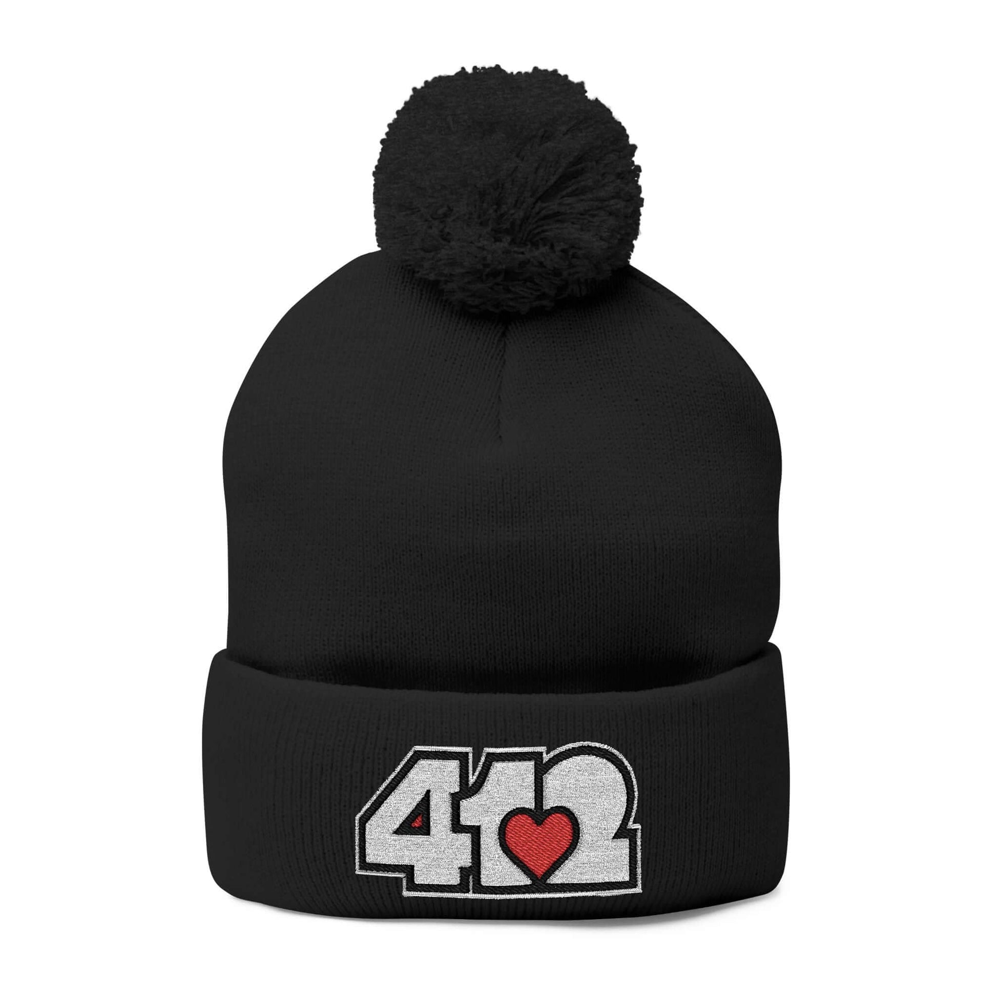 Cozy 412 Tossle Cap | Embroidered White and Red Logo. Apparel Color: Black. Has soft acrylic knit, fold-over cuff, and one-size fit for winter comfort.