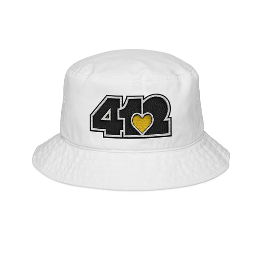 412 White Gilligan Crown bucket hat with embroidered yellow heart and black 412 logo; vibrant Pittsburgh streetwear with a sunny, with a sunny, feel-good aesthetic.