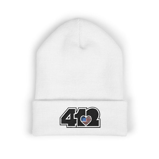 White 412 Skull Crown beanie with Stars & Stripes embroidered heart and black logo, channeling Pittsburgh streetwear with regal edge and radiant contrast.