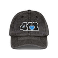 Pittsburgh Vintage Hat | Embroidered Black and Blue 412 Logo. Apparel Color: Black. A relaxed fit, cotton twill fabric, adjustable buckle, and washed-out finish look.