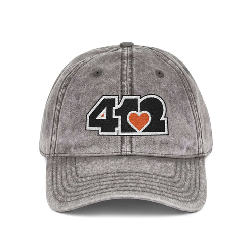 Pittsburgh Vintage Hat | Embroidered Black and Orange 412 Logo. Apparel Color: Charcoal Grey. A relaxed fit, cotton twill fabric, adjustable buckle, and washed-out finish look.