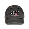 Pittsburgh Vintage Hat | Embroidered Black and Pink 412 Logo. Apparel Color: Black. A relaxed fit, cotton twill fabric, adjustable buckle, and washed-out finish look.