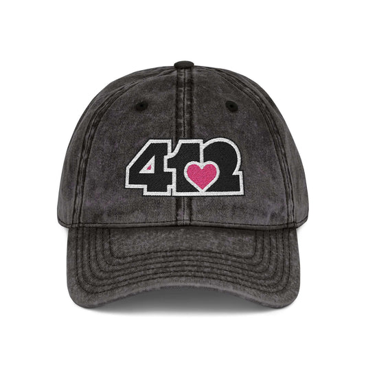 Pittsburgh Vintage Hat | Embroidered Black and Pink 412 Logo. Apparel Color: Black. A relaxed fit, cotton twill fabric, adjustable buckle, and washed-out finish look.
