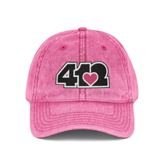 Pittsburgh Vintage Hat | Embroidered Black and Pink 412 Logo. Apparel Color: Pink. A relaxed fit, cotton twill fabric, adjustable buckle, and washed-out finish look.