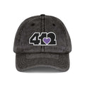 Pittsburgh Vintage Hat | Embroidered Black and Purple 412 Logo. Apparel Color: Black. A relaxed fit, cotton twill fabric, adjustable buckle, and washed-out finish look.