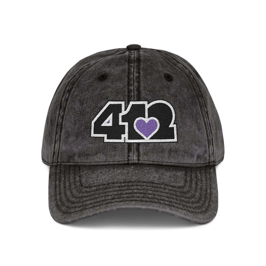 Pittsburgh Vintage Hat | Embroidered Black and Purple 412 Logo. Apparel Color: Black. A relaxed fit, cotton twill fabric, adjustable buckle, and washed-out finish look.