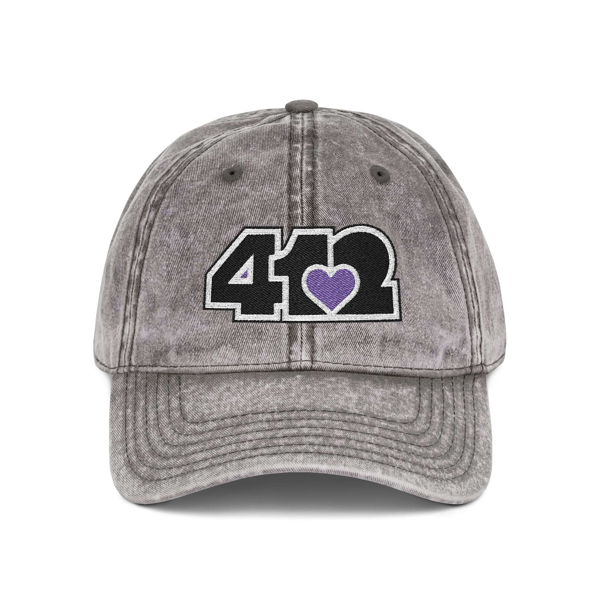 Pittsburgh Vintage Hat | Embroidered Black and Purple 412 Logo. Apparel Color: Charcoal Grey. A relaxed fit, cotton twill fabric, adjustable buckle, and washed-out finish look.
