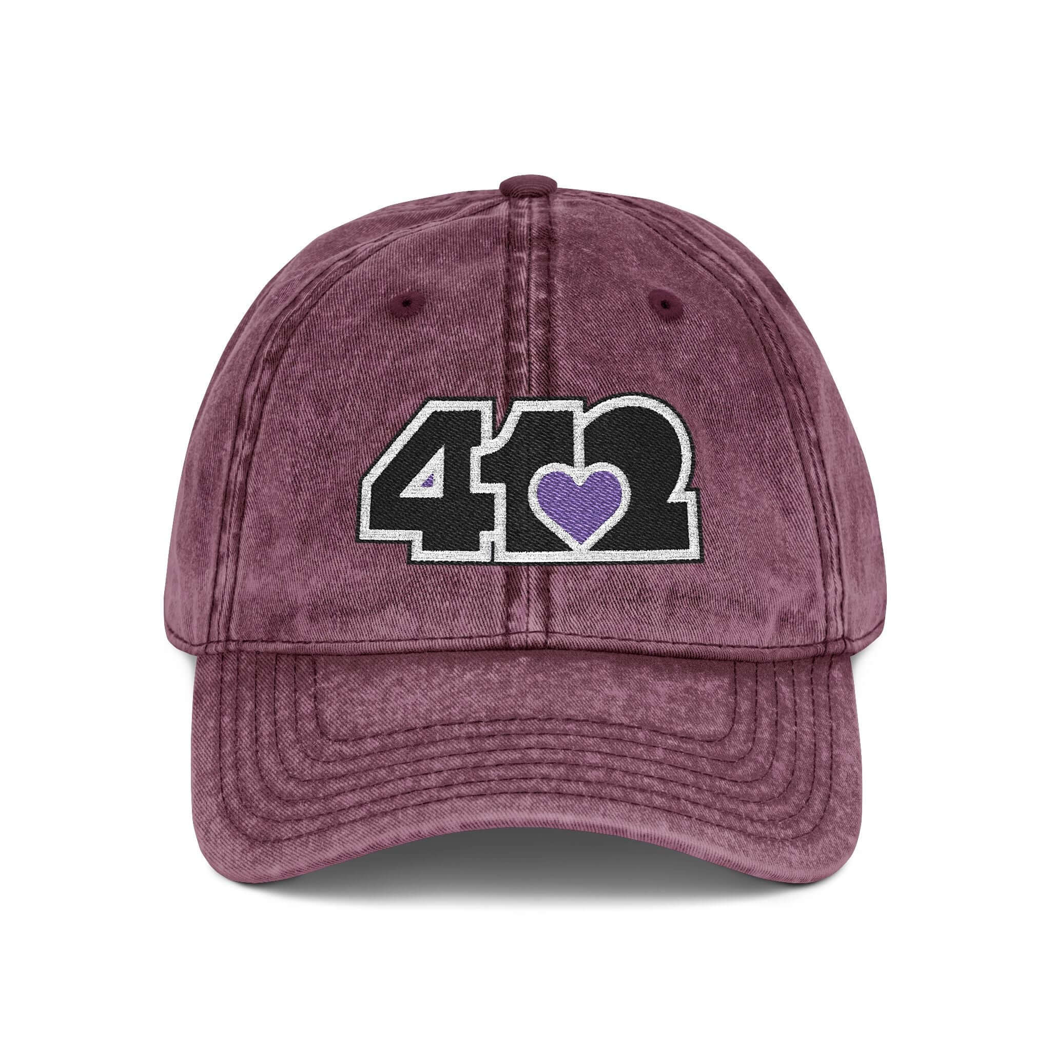 Pittsburgh Vintage Hat | Embroidered Black and Purple 412 Logo. Apparel Color: Maroon. A relaxed fit, cotton twill fabric, adjustable buckle, and washed-out finish look.