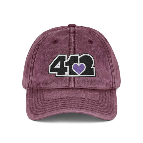 Pittsburgh Vintage Hat | Embroidered Black and Purple 412 Logo. Apparel Color: Maroon. A relaxed fit, cotton twill fabric, adjustable buckle, and washed-out finish look.