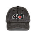 Pittsburgh Vintage Hat | Embroidered Black and Red 412 Logo. Apparel Color: Black. A relaxed fit, cotton twill fabric, adjustable buckle, and washed-out finish look.