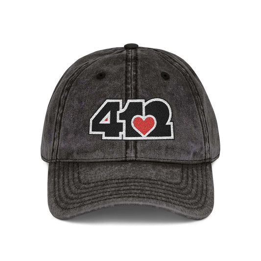 Pittsburgh Vintage Hat | Embroidered Black and Red 412 Logo. Apparel Color: Black. A relaxed fit, cotton twill fabric, adjustable buckle, and washed-out finish look.