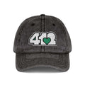 Pittsburgh Vintage Hat | Embroidered White and Green 412 Logo. Apparel Color: Black. A relaxed fit, cotton twill fabric, adjustable buckle, and washed-out finish look.