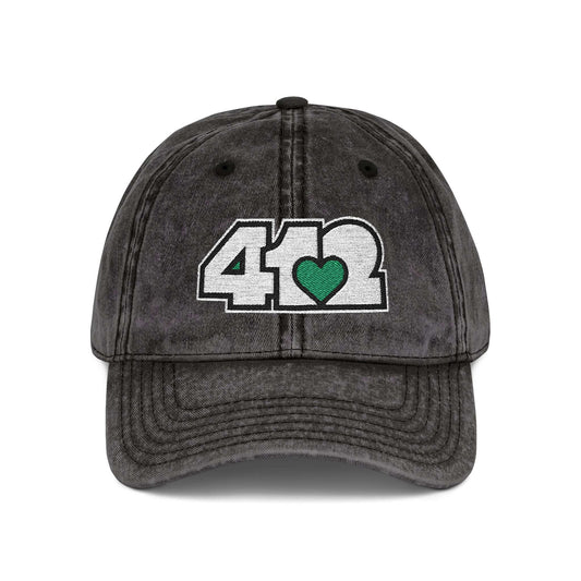 Pittsburgh Vintage Hat | Embroidered White and Green 412 Logo. Apparel Color: Black. A relaxed fit, cotton twill fabric, adjustable buckle, and washed-out finish look.