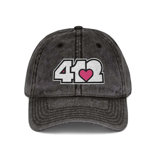 Pittsburgh Vintage Hat | Embroidered White and Pink 412 Logo. Apparel Color: Black. A relaxed fit, cotton twill fabric, adjustable buckle, and washed-out finish look.