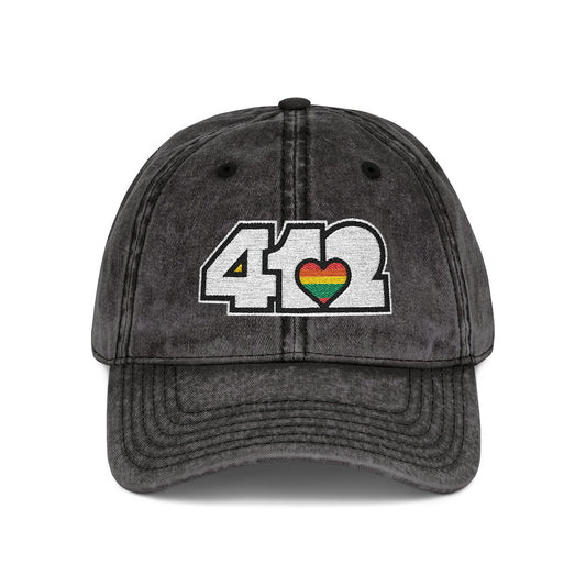 Pittsburgh Vintage Hat | Embroidered White and Rainbow 412 Logo. Apparel Color: Black. A relaxed fit, cotton twill fabric, adjustable buckle, and washed-out finish look.