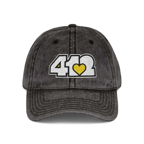 Pittsburgh Vintage Hat | Embroidered White and Yellow 412 Logo. Apparel Color: Black. A relaxed fit, cotton twill fabric, adjustable buckle, and washed-out finish look.