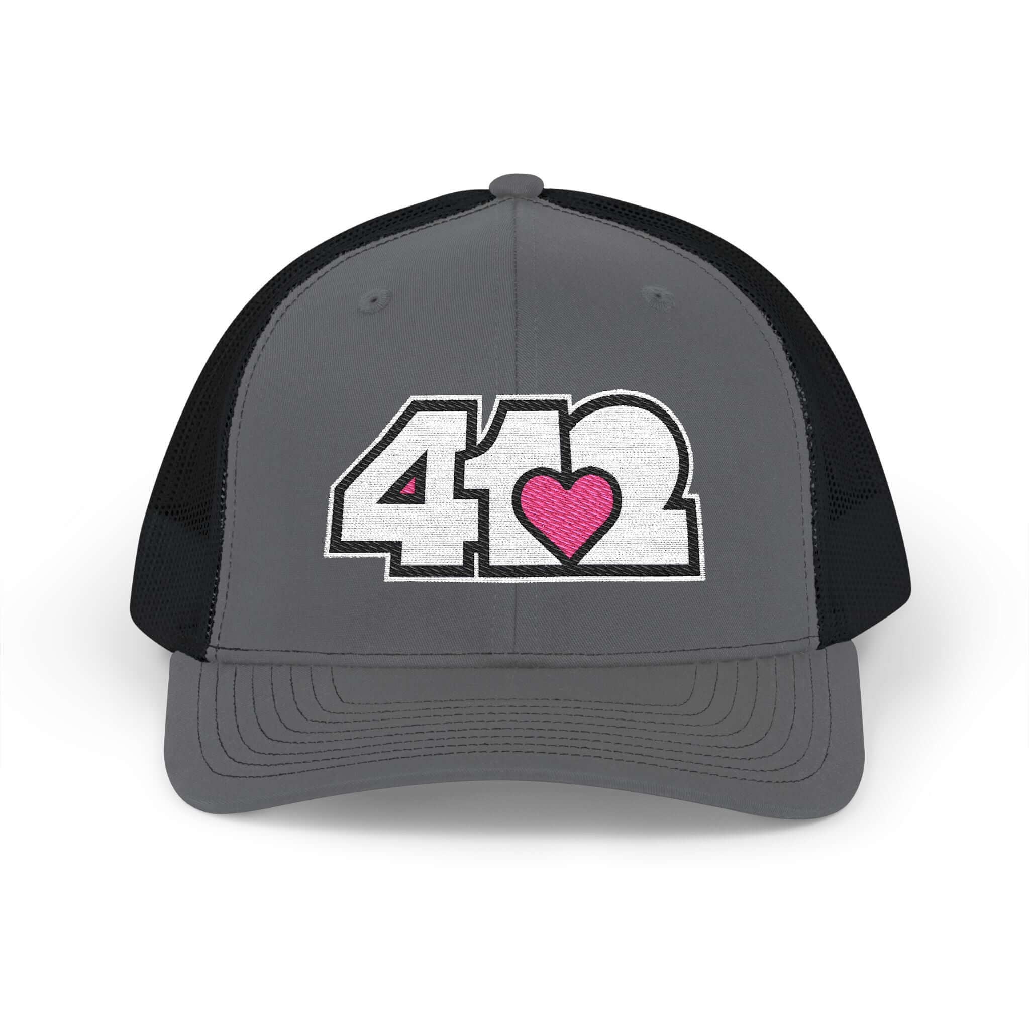 Snapback Hat | Embroidered White and Pink 412 Logo. Apparel Color: Charcoal/Black. A comfy mid-profile adjustable fit for everyday flair