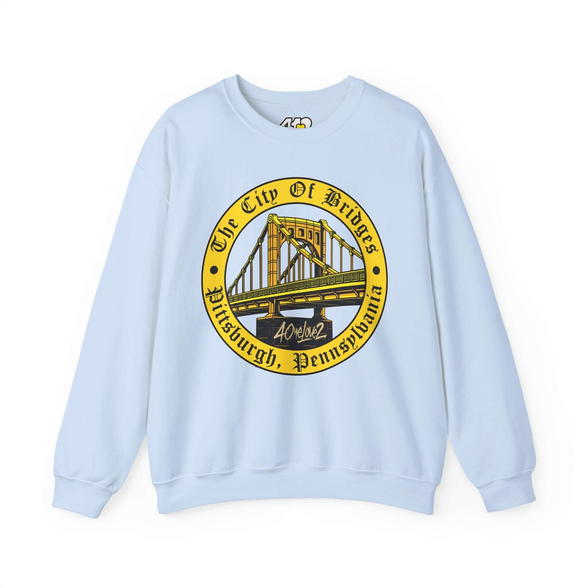 The City of Bridges Sweatshirt. Apparel Color: Light Blue. A blend of 50% cotton and 50% polyester for cozy durability. With an Elastic ribbed collar, and Double-needle stitching.