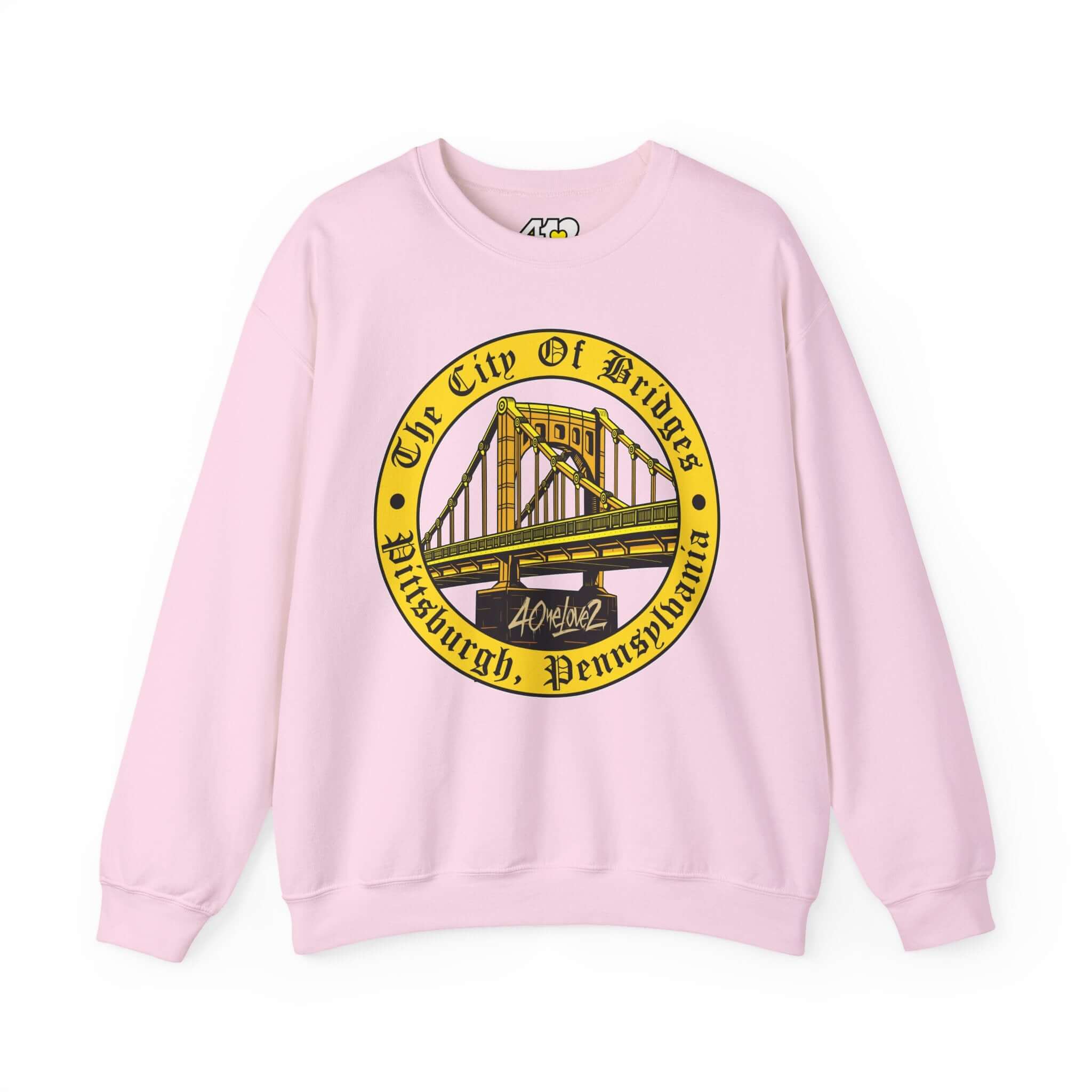 The City of Bridges Sweatshirt. Apparel Color: Light Pink. A blend of 50% cotton and 50% polyester for cozy durability. With an Elastic ribbed collar, and Double-needle stitching.