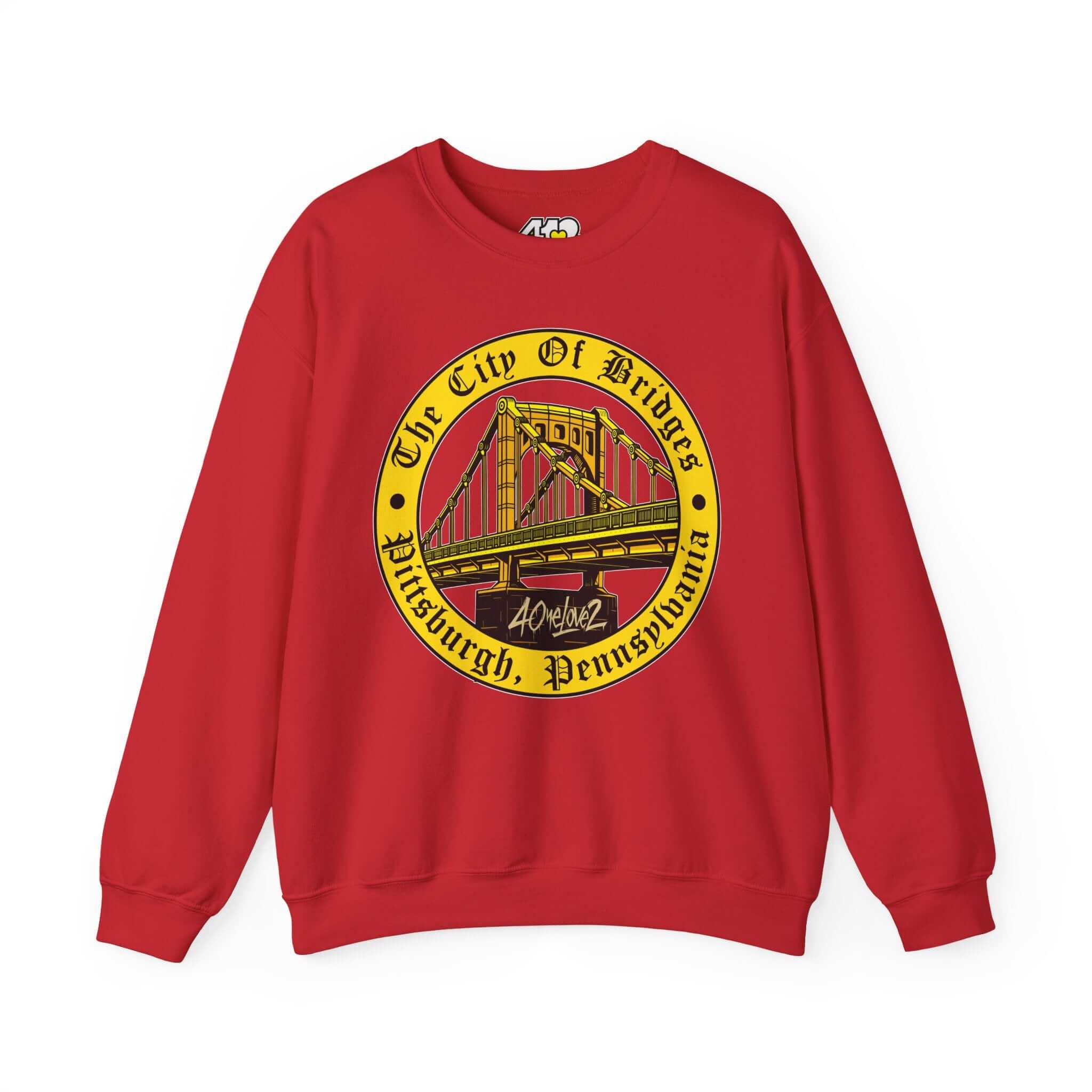 The City of Bridges Sweatshirt. Apparel Color: Red. A blend of 50% cotton and 50% polyester for cozy durability. With an Elastic ribbed collar, and Double-needle stitching.