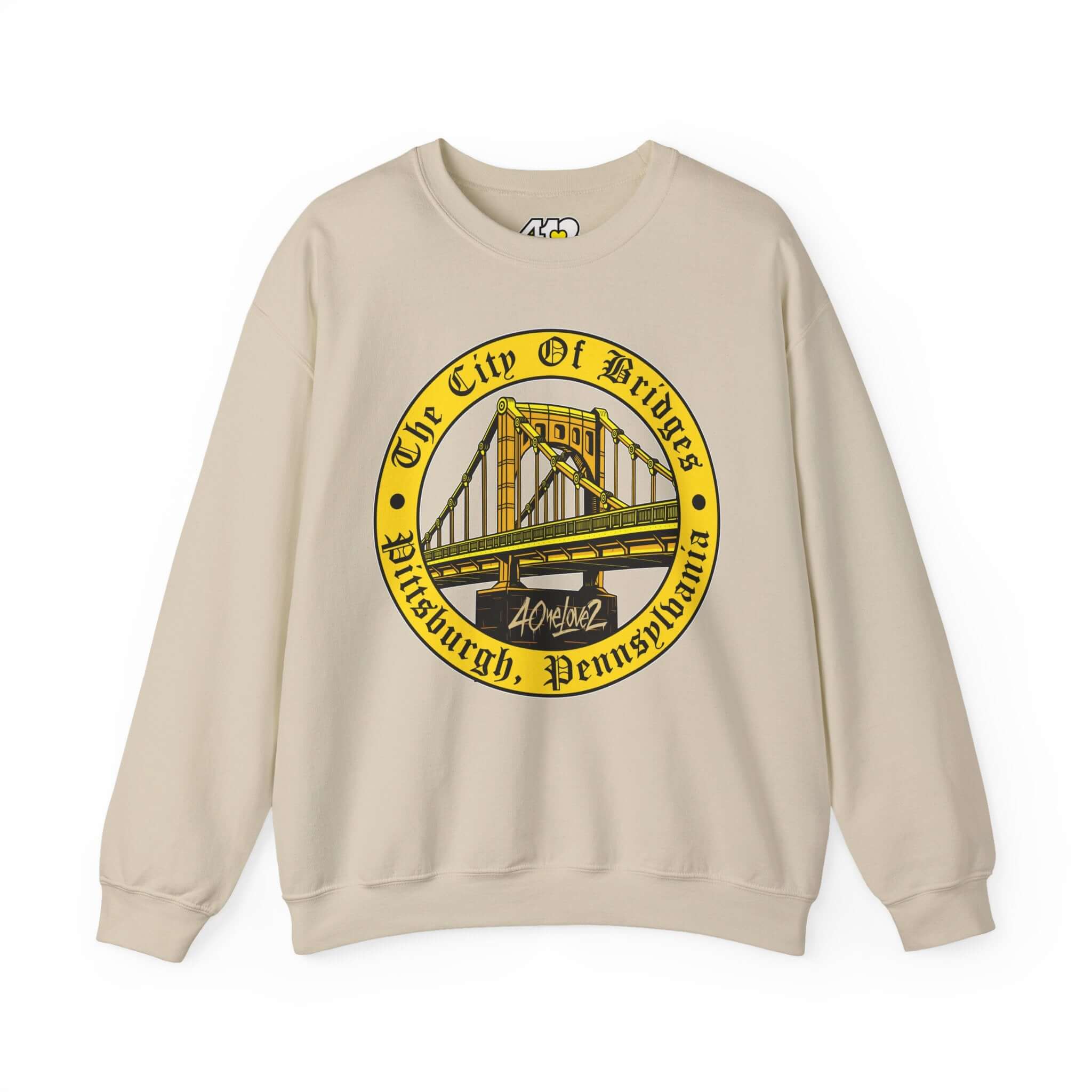 The City of Bridges Sweatshirt. Apparel Color: Sand. A blend of 50% cotton and 50% polyester for cozy durability. With an Elastic ribbed collar, and Double-needle stitching.